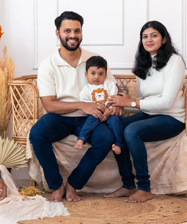 A classic family pose in our popular boho setup. The natural elements and warm lighting create a cozy and inviting atmosphere for a timeless family photograph.