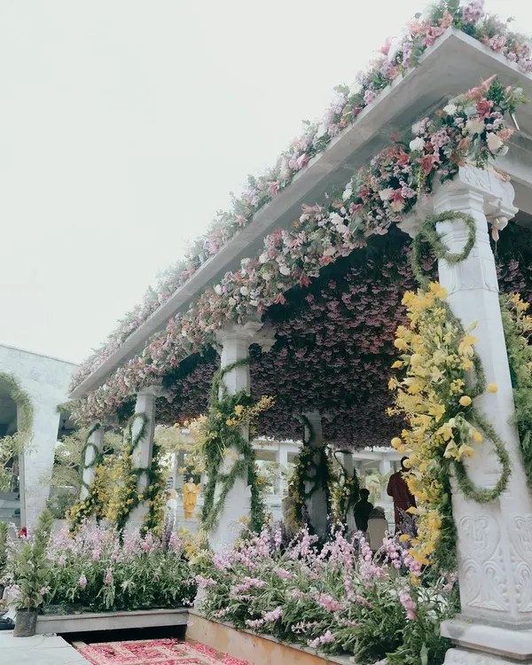 The mandap for Nithya and Payton's wedding in Nandi Hills was a garden paradise. We covered the structure in a dense canopy of pink blooms and wrapped the pillars in spiraling yellow flowers to create a vibrant, joyful space for their ceremony.