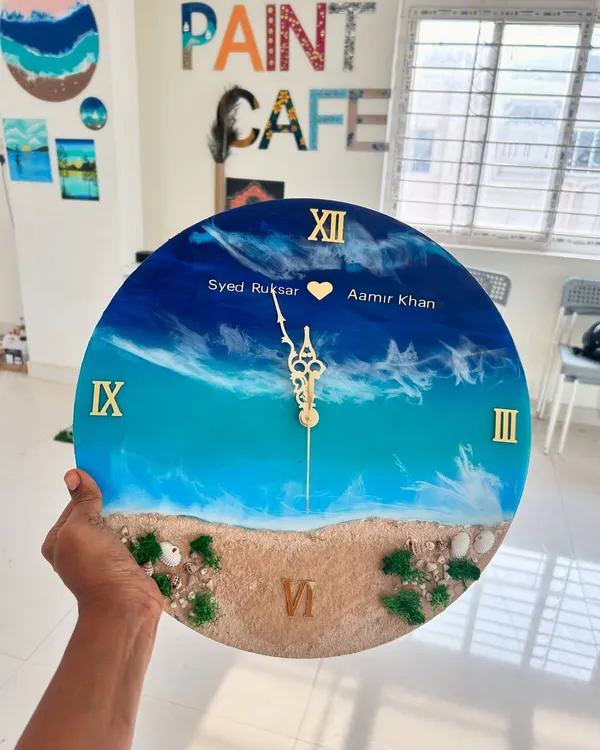 A beautiful personalized resin beach clock created by a couple in our workshop. It's a wonderful way to commemorate a special bond while creating a functional piece of art for your home.