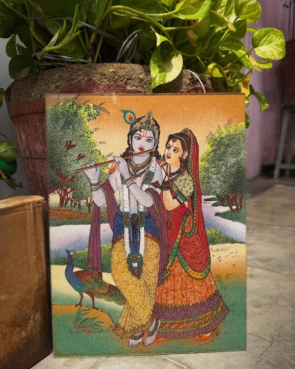 I created this piece to portray the divine love between Radha and Krishna. Every element, from the serene landscape to the peacock at their feet, is rendered with natural gemstones to reflect the harmony and spiritual connection they represent. This artwork is intended to bring a feeling of peace and devotion into your home.
