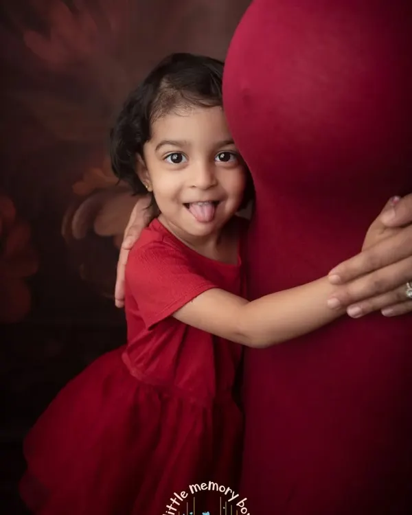 The bond between a big sister and her unborn sibling is just magical. I love this playful moment, a sweet hug for the baby bump filled with so much love and excitement.