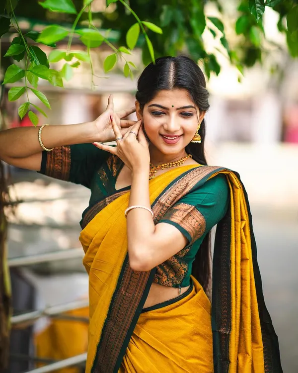 Modeling a beautiful yellow 'Manjal' cotton saree. The hand gestures of Bharatanatyam lend a unique grace to ethnic wear photoshoots.