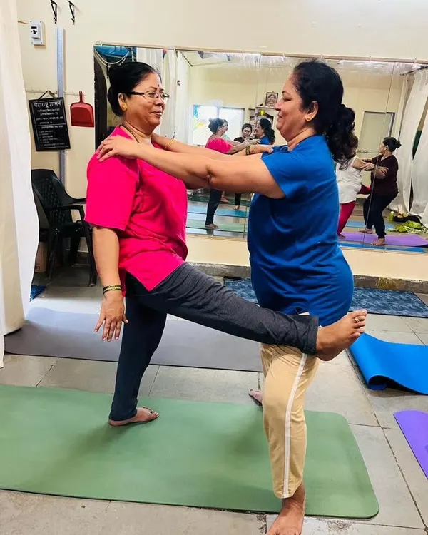 A beautiful moment of connection and support between two students in my class. Partner stretches like this help improve balance and flexibility while fostering a sense of community.