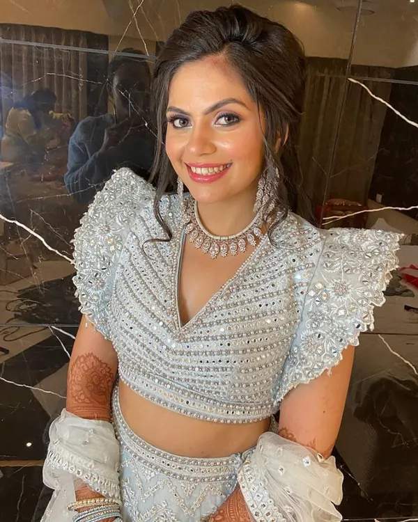 A close-up of a happy client in our powder blue and silver lehenga. The intricate mirror work on the blouse is a detail we absolutely love.