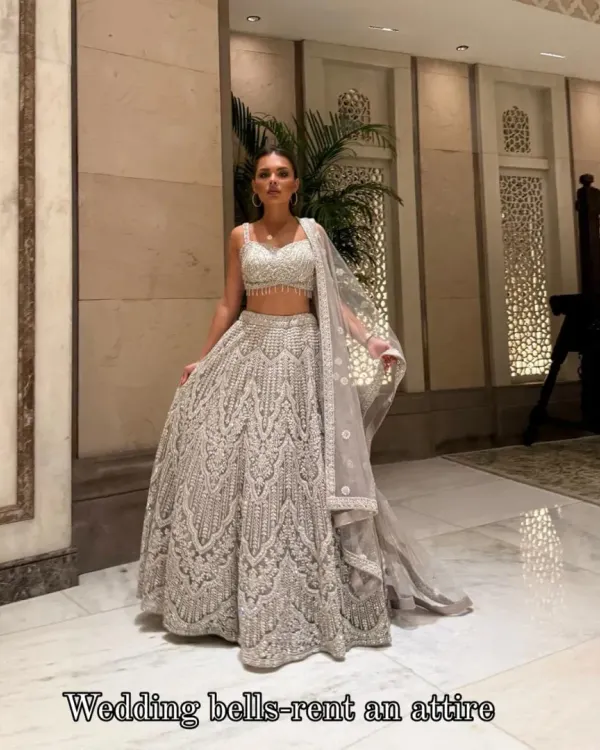 My gorgeous client dazzling in a heavy silver lehenga. She looks like a dream, twirling and shining at her event. This is the magic of renting luxury!