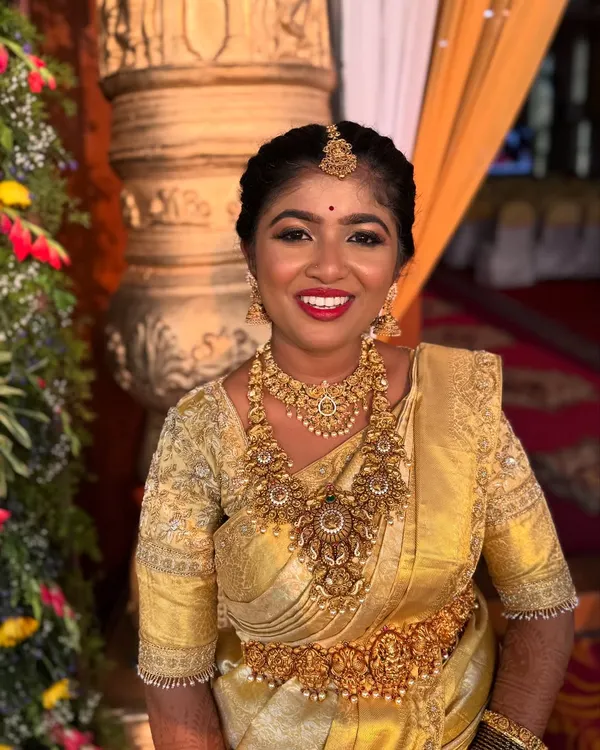 A radiant bride ready for her muhurtham. This is a completely unedited photo, showcasing the true glow and finish of her makeup in natural lighting.