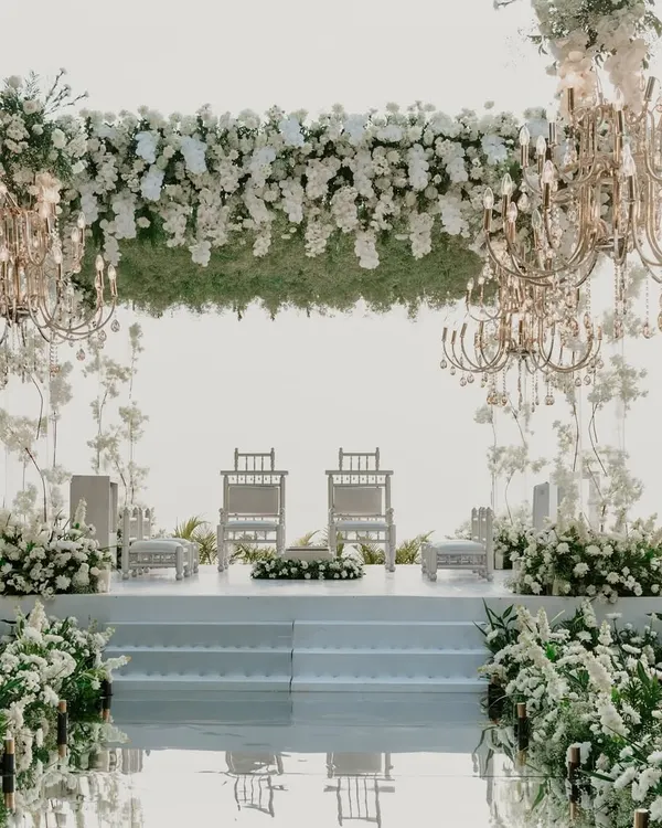 An all-white mandap against the Goa sea is pure magic. For this ceremony at the Grand Hyatt, we used a mirrored aisle, floating floral structures, and elegant chandeliers to create a space that felt like walking on clouds.