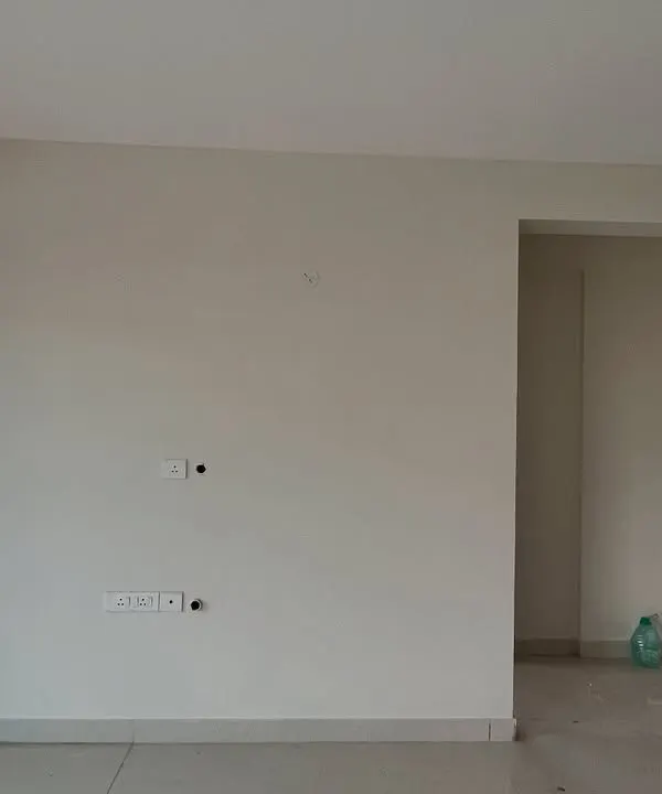 Before: An empty living room wall in 'The Flux Abode'. This is the blank canvas I start with.