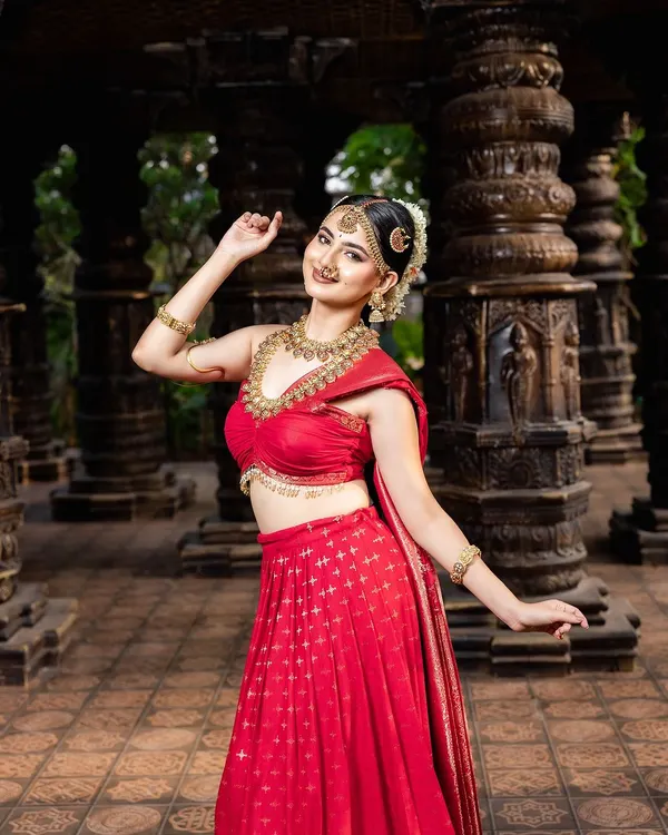 A breathtaking look featuring a traditional red half-saree paired with my classic temple jewellery. This shows how you can achieve a divine, traditional look even without a full saree.