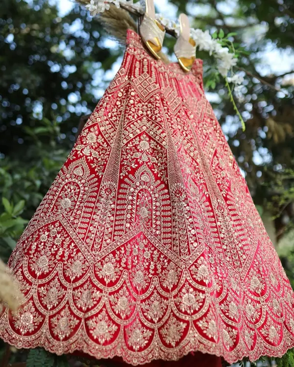 Get your dream wedding lehenga, whether you want it custom-stitched or on rent. This stunning red velvet piece is a classic choice for any bride.