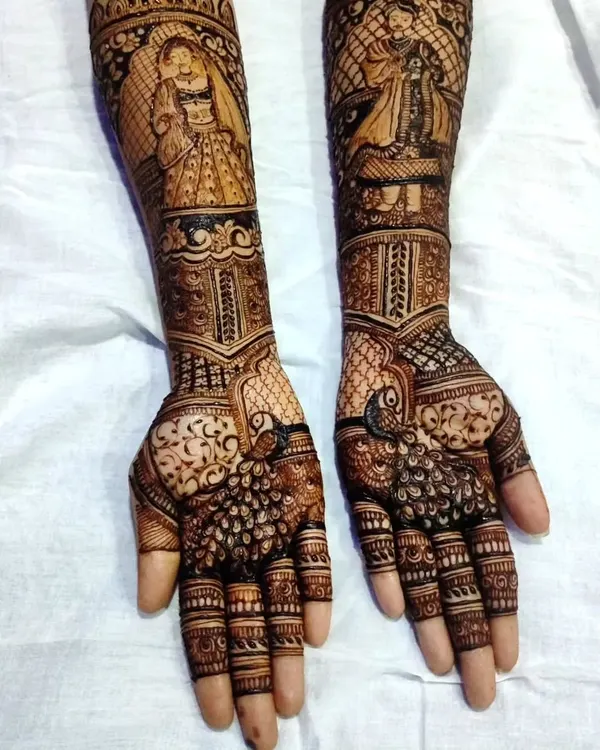 A full view of the bride and groom portrait henna. This traditional Rajasthani style of art tells a story and is a beautiful way to celebrate your union.