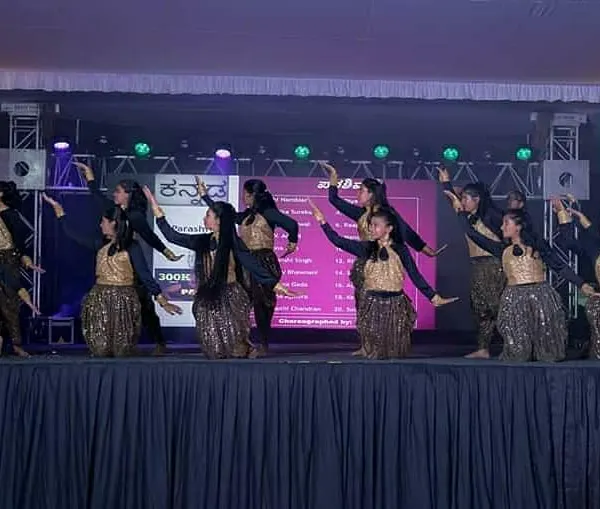 A large group of women performing a synchronized piece for the Kannada Rajyotsava community celebration. Coordinating big groups to move as one is a challenge I absolutely love.
