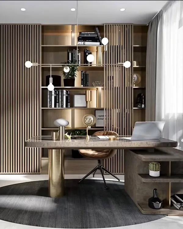 We designed this luxurious home office with a focus on sophistication and function. The space features a statement desk, extensive built-in bookshelves with a slatted wood screen, and a modern chandelier, creating an executive-level workspace at home.