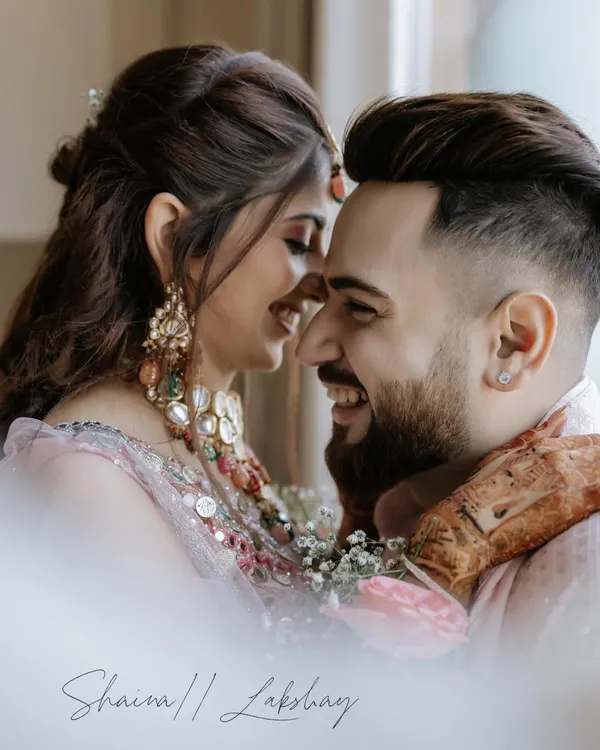 The purest joy is found in a shared laugh. This close-up portrait captures an unscripted moment of happiness between the couple, their smiles telling a story of deep connection and friendship.