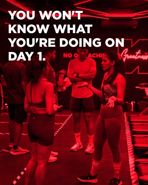 You won't know what you're doing on day one, and that is perfectly okay. Here, a coach explains the workout to a small group, ensuring everyone feels clear and supported before they begin.