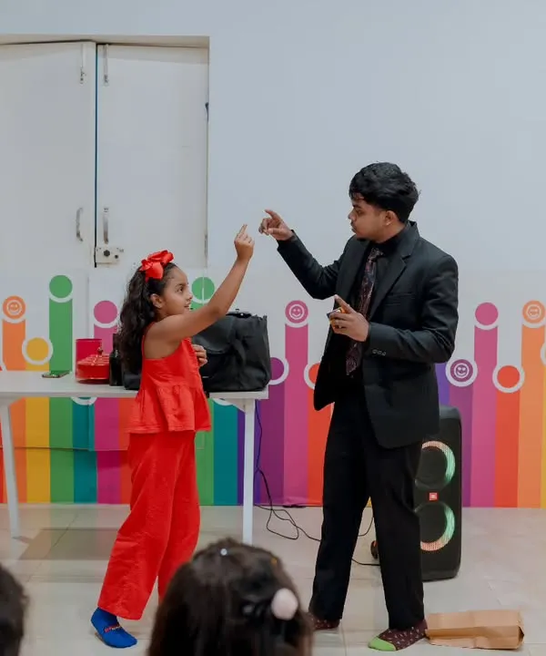 This picture perfectly captures the essence of my interactive magic. A young girl becomes the magician, creating a special moment of empowerment and fun for everyone watching.