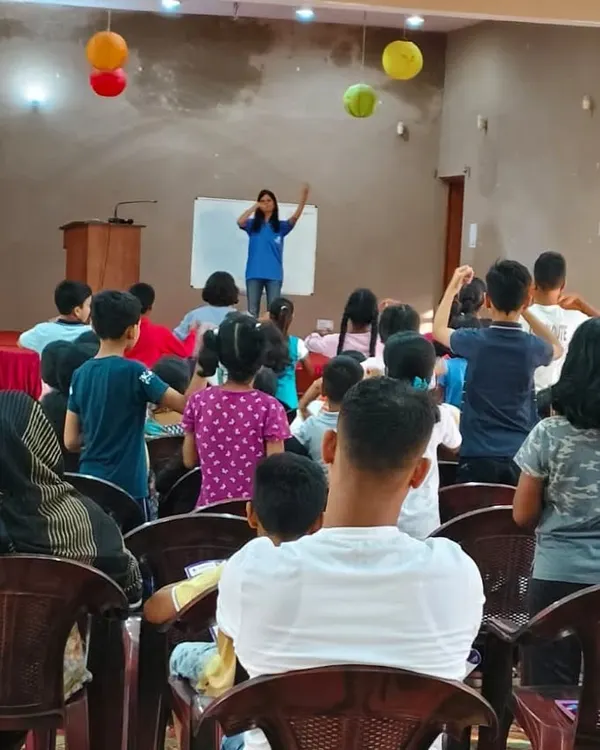 A view from the back of our parent counseling and demo session in Ranchi. You can see children actively participating on stage while parents observe. We believe in involving the entire family in the learning process.