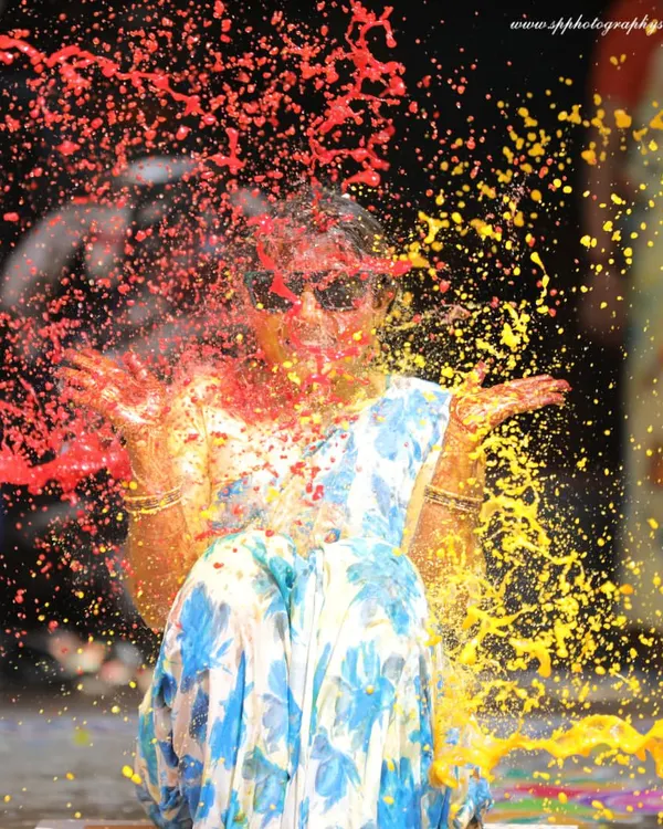 Capturing the explosion of color and fun during a Haldi ceremony. This high-energy shot freezes the moment perfectly, showcasing the joy and playful spirit of the event.