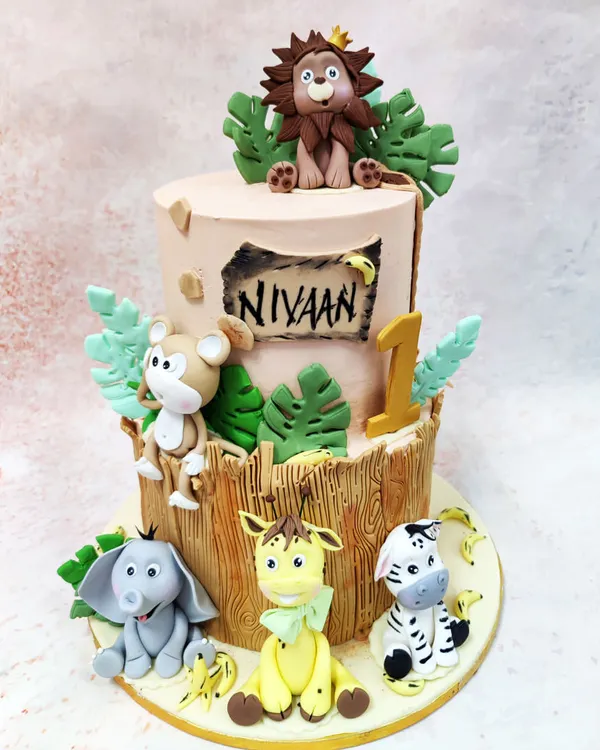 Our two-tier Bamboo Safari Cake is a jungle celebration, featuring a crowned lion, monkey, elephant, giraffe, and zebra in a lush, wood-textured setting.