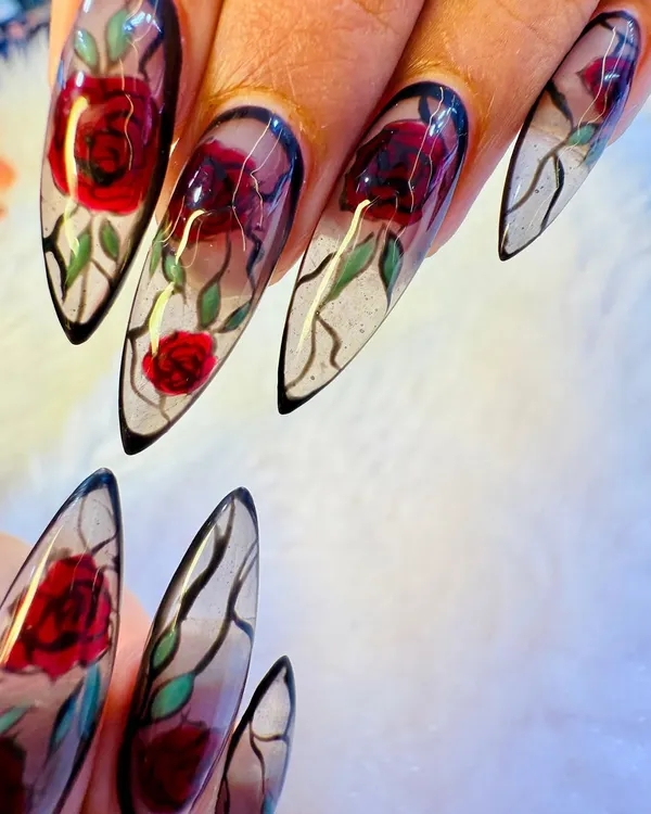 A true work of art. Our artist hand-painted these detailed red roses on long, stiletto-shaped extensions with a translucent, glass-like finish for a stunning 'enchanted rose' effect.