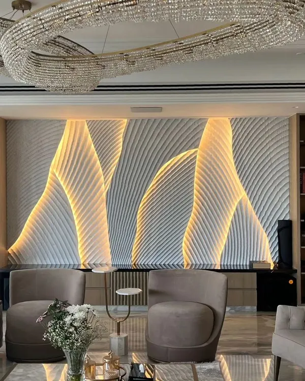 This is what we mean by a feature wall. We used sculpted stone panels with integrated backlighting to create this fluid, wave-like effect. It’s a piece of art that completely defines the living space, offering a dynamic look that changes from day to night.