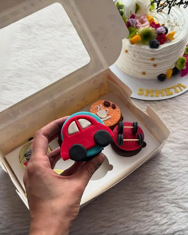 A close-up of one of my custom fondant cupcakes. This little red car was part of a set designed for a car lover's birthday, showing how we can personalize each cupcake to a theme.