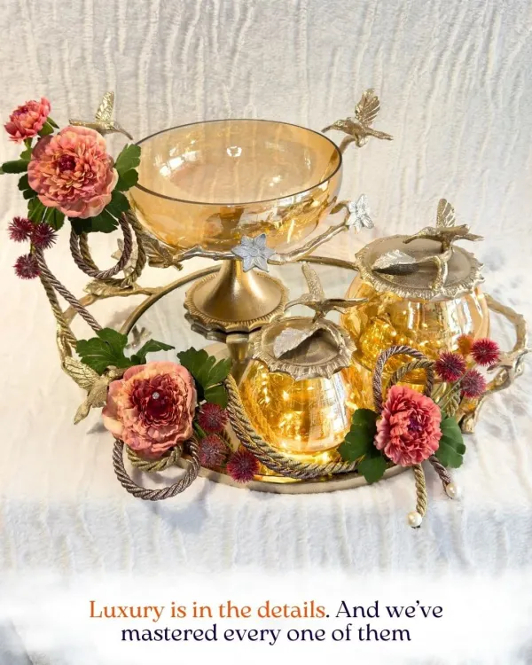 Luxury is in the details, and I have mastered every one of them. This gilded hamper, adorned with delicate florals and amber-toned glass, is a perfect example of how I blend opulence with artistry to create a truly memorable gift.
