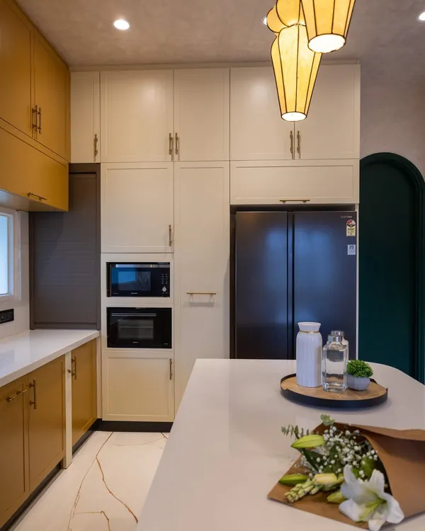 The open kitchen in the 'Sukoon' project, showing the built-in microwave and oven tower and the seamless integration with the living space.