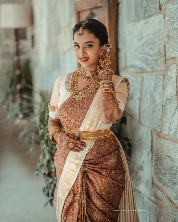 A portrait of timeless South Indian bridal beauty. I focus on capturing the intricate details of the silk saree, the temple jewelry, and the bride's serene expression.