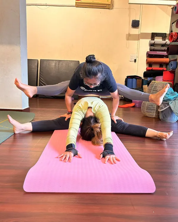 Posing once again with my favorite girl. This partner stretch combines a wide-legged forward fold with a firefly arm balance, requiring trust and stability from both partners.