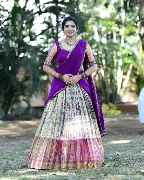 Dr. Nikitha looks absolutely radiant in this custom langa voni, created from a beautiful silk saree. The rich purple and intricate gold border were preserved to create this timeless piece.