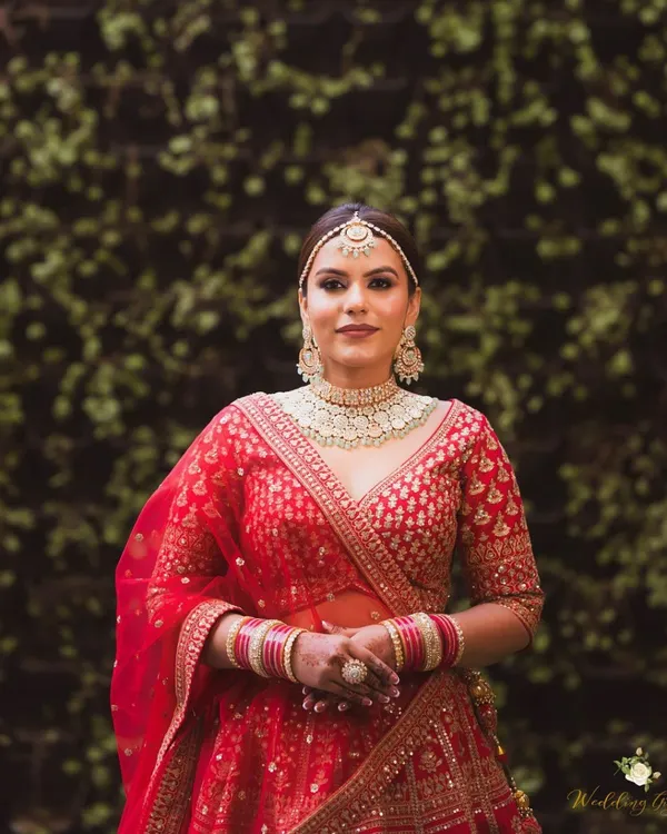For this bride, the focus was on creating a regal and radiant look. I used a combination of soft contouring and a luminous foundation to give her a sculpted yet natural finish that perfectly complements her red lehenga.