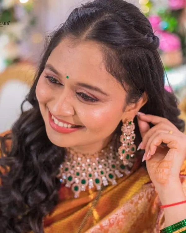 A happy client looking beautiful in our American diamond and green bead necklace set. Her smile is our best testimonial.