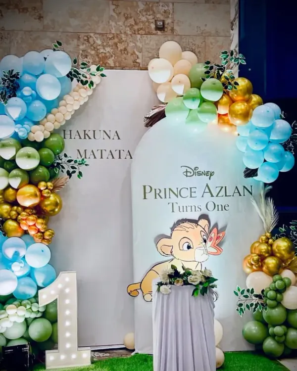 A stunning Lion King first birthday setup for Prince Azlan. We used custom backdrops, jungle-colored balloons, and a light-up '1' to create a memorable "Hakuna Matata" celebration.