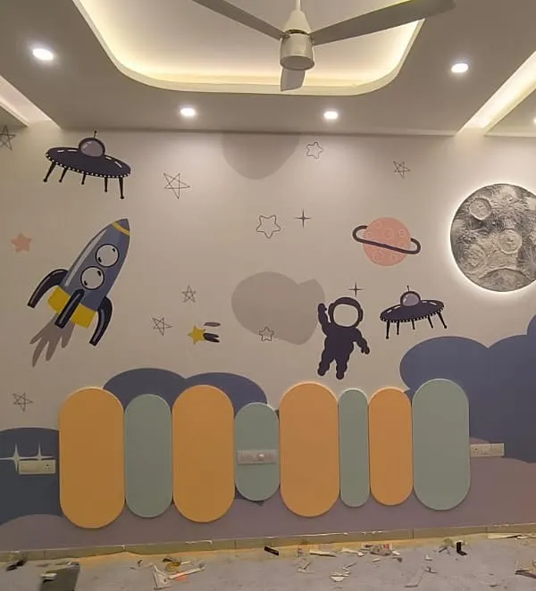 To the moon and beyond! This kids' bedroom features a complete space adventure with rockets, planets, and aliens, centered around a textured 3D moon mural that lights up.