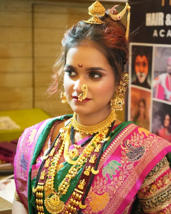 This is the classic Peshwai bridal look, a masterpiece of Maharashtrian tradition that we specialize in. We teach you how to perfect every detail, from the iconic 'chandrakor' bindi to the authentic jewelry placement, creating a look of pure royalty.