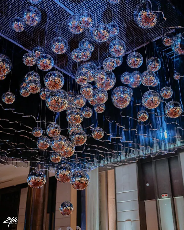 The showstopper of our 'Love & Illusion' Sangeet was this incredible ceiling installation of hundreds of disco balls, creating a magical, starry night effect.