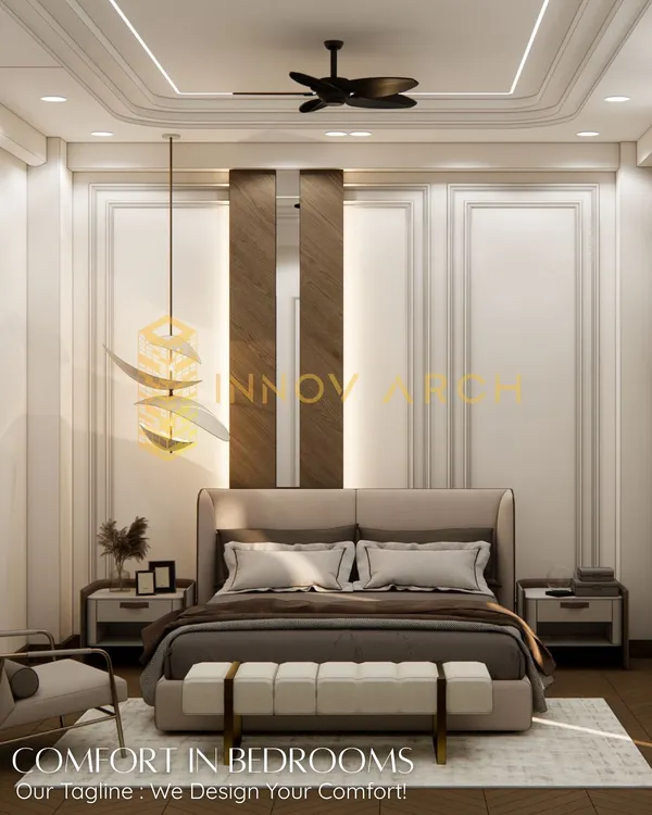 A serene and comfortable master bedroom design for a modern villa in Akansha Enclave. The room features classic wall moulding, a statement pendant light, and a balanced color palette, creating a perfect space for relaxation.