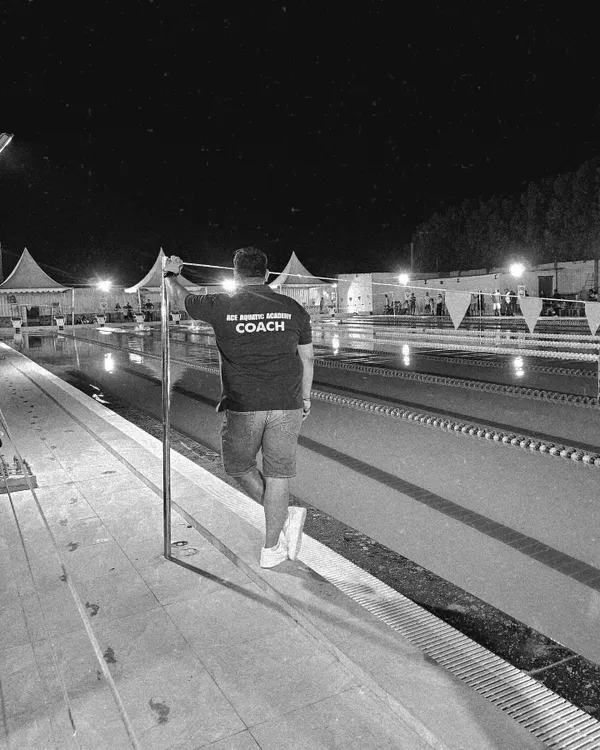 A quiet moment of reflection by the pool after a long day of coaching. My vision is to constantly strive for greatness and create a legacy of success for my swimmers.