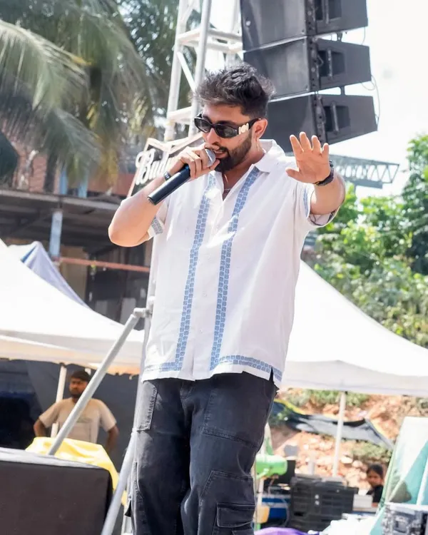 On the mic at a Holi festival, getting the crowd hyped up. There's nothing like the energy of an outdoor day party.