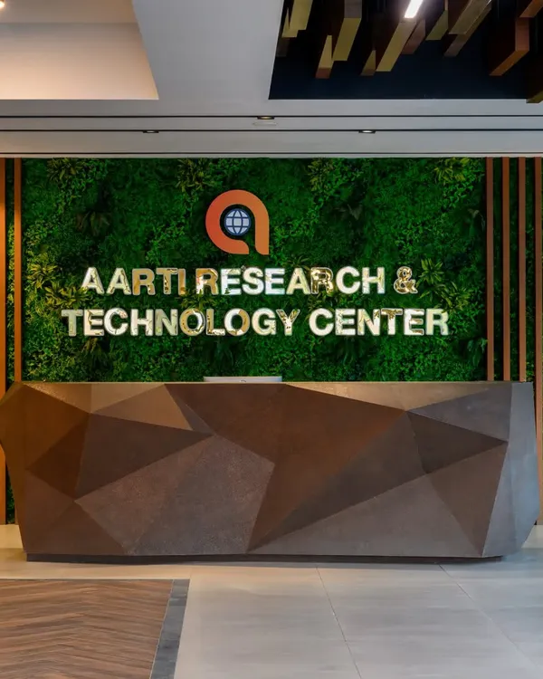 A close up of the sculptural reception desk I designed. The custom faceted shape gives it a unique, modern feel, while the moss wall behind it brings a touch of nature indoors and makes the company branding pop.