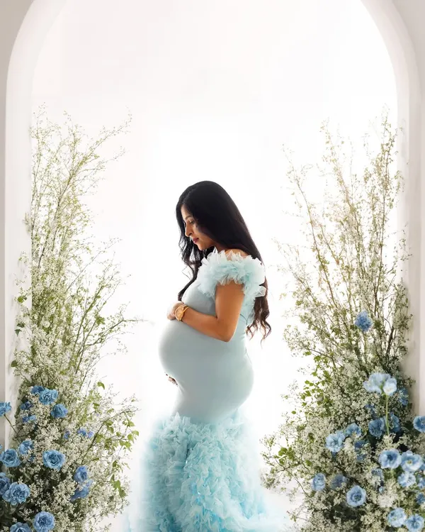 A truly magical shot of this mommy-to-be in a stunning blue ruffled gown, framed by an arch of blue and white flowers. This is one of my most requested setups for a reason.