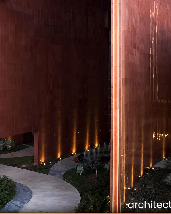 At the Surat Diamond Bourse, the world's largest office building, the landscape is integral to the design. The illuminated pathways and water features within the courtyards create a serene atmosphere at night, extending the usability of these social spaces beyond working hours.
