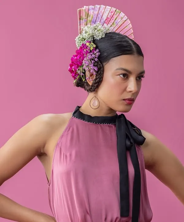 A key shot from the "Rainforest" series, where I combined a sculptural floral headpiece with a soft, halter-neck dress against a vibrant pink backdrop. This look is a perfect example of my avant-garde styling, blending natural elements with high fashion.