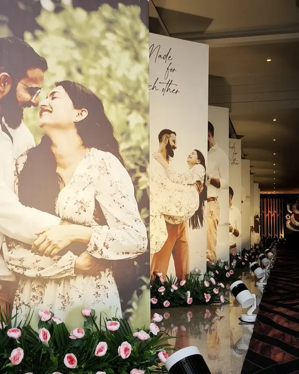 A truly personal wedding aisle. I designed this entrance walkway lined with life-size photos of the couple, telling their love story to guests as they arrived.