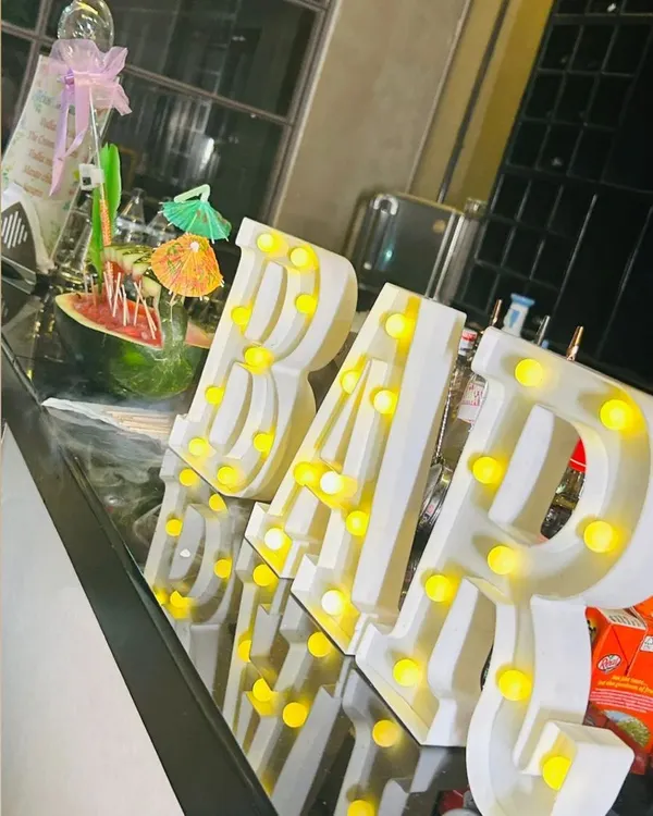 A close-up of our illuminated "BAR" sign on a sleek, modern bar counter. This decorative element adds a professional and festive touch to any event space.
