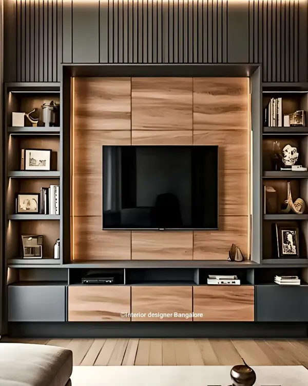 This entertainment center is a perfect example of our mixed-material design approach. We combined dark grey cabinetry with natural wood paneling and integrated vertical shelving, creating a balanced and modern focal point for the living room.