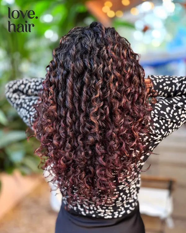 This is finger coiling at its best. A beautiful, non-bleach colour on these defined curls adds a hint of warmth and dimension without compromising the curl pattern.