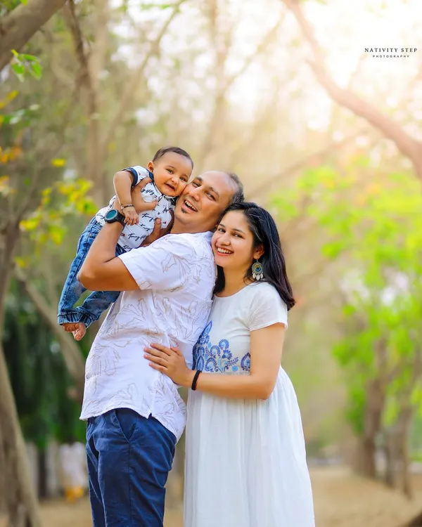 There's nothing better than a candid laugh. This outdoor family portrait, taken during the golden hour, captures a moment of pure happiness and connection.