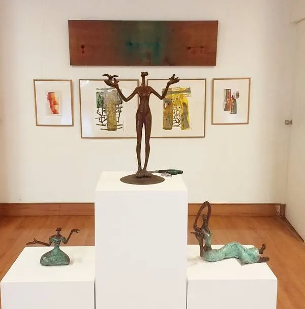Welcome to our gallery space. This view from our "Beyond Boundaries" group exhibition captures the diverse range of art we showcase, from striking bronze sculptures to vibrant contemporary paintings, all thoughtfully arranged to create a cohesive visual experience.